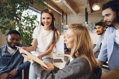 a group of paid advertising experts in an advertising agency, sitting around a table